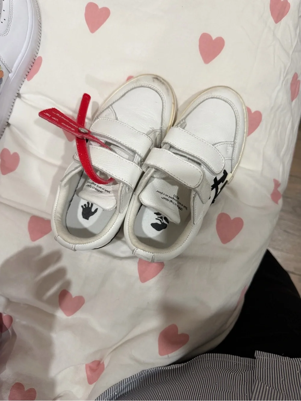 Off- White Sneakers with Black Arrow Logo and Red Lace Accent